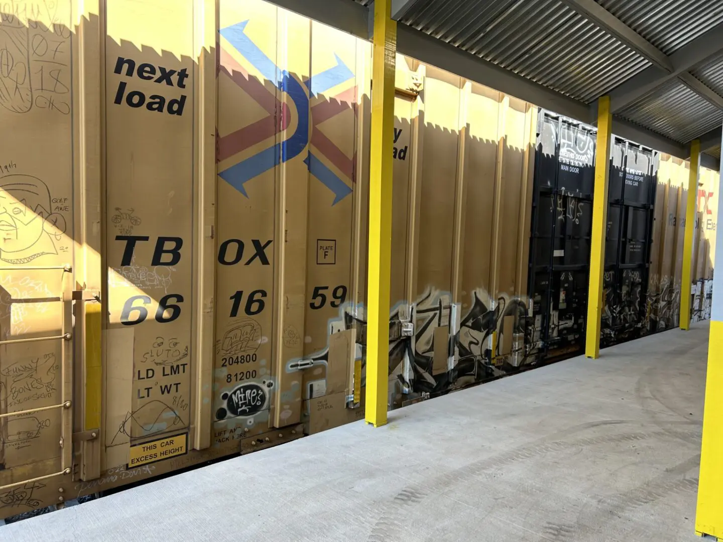 Freight train boxcar with graffiti art.